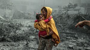 A woman holding a girl reacts after Israeli airstrikes hit Ridwan neighborhood of Gaza City, Gaza, on Oct. 23.