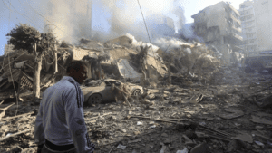 A man walks amid the rubble of a building leveled in an overnight Israeli airstrike that targeted the neighborhood of Moawwad in Beirut's southern suburbs Thursday, Oct. 4.