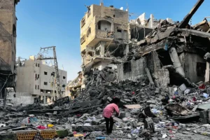 A Palestinian girl looks through the rubble of a building after an Israeli strike in Beit Lahia, northern Gaza, on Tuesday October, 30th, 2024.