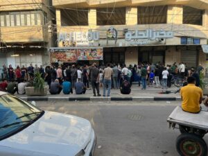 Residents and people displaced by conflict in Khan Younis, Gaza, looking for food gather at a bakery on October 16. Most bakeries in Gaza are unable to produce any bread due to the lack of flour and electricity.