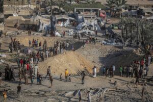 Palestinians are seen around the 9-meter-deep hole left by Israeli air strikes on a tent encampment Khan Yunis, Gaza on September 10, 2024