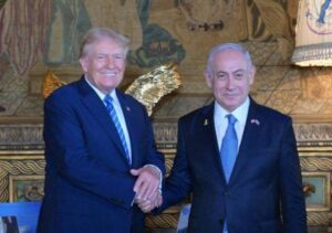 Former US President Donald Trump (L) shakes hands with Israeli Prime Minister Benjamin Netanyahu (R) as they pose for a photo within their meeting at Mar-a-Lago estate, in Palm Beach, Florida, United States on July 26, 2024