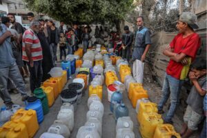 Palestinians who had to migrate to central part of Gaza to protect themselves from Israeli attacks, wait in queues to receive clean drinking water amid Israeli attacks in Deir al-Balah, Gaza on October 19, 2024.