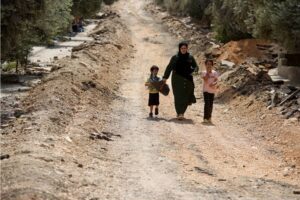 According to a September 2024 report by Defense for Children International, Israel has been killing one Palestinian child every two days in illegally occupied West Bank (Pictured: A woman walks with children in a destroyed part of Jenin in West Bank, September 1, 2024) 