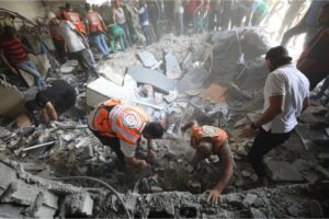 Palestinian residents and civil defence teams launch a search and rescue operation following an Israeli attack on the Remal Clinic on al-Wehda Street in Gaza City