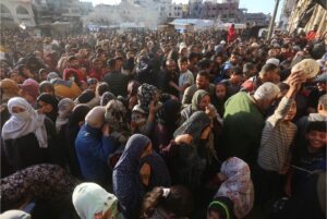 Displaced people queue for bread outside of a bakery in Khan Younis, southern Gaza, November 2024.