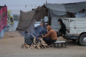 Palestinians who fled their homes due to Israeli attacks in the Gaza Strip struggle with cold weather conditions in makeshift tents in the southern city of Khan Younis, on November 25, 2024