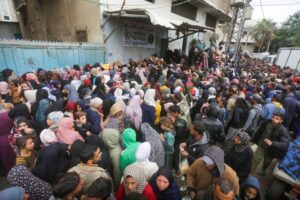 Hundreds of Palestinians wait for their turn in front of a bakery to buy bread under hard conditions in Deir Al Balah, Gaza on November 27, 2024