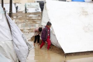 Palestinians who stay in makeshift tents after fleeing their homes for safety struggle with flooding due to heavy rainfall in Deir al-Balah, Gaza on January 27, 2024.