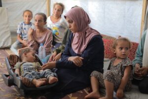 The 11-month-old Abdul Rahman Abu al-Jidyen, who is suffering from polio, sleeps on his carrycot by his family in Deir Al Balah, Gaza on August 27, 2024.