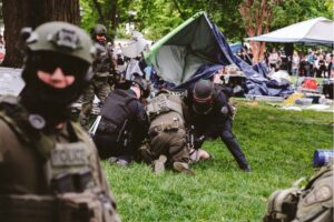 Heavily armed policemen arrests a protester on university grounds after the police declared an unlawful gathering to disperse protesters encampment on the grounds of the University of Virginia in Charlottesville, Virginia. on 4 May, 2024