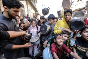 Hungry Palestinian children wait in line to receive meals distributed by charities in Gaza City, Gaza, on November 03, 2024