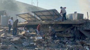 People inspect the damage at the site of an Israeli airstrike that targeted the village of al-Ain near Baalbek in Lebanon's eastern Bekaa Valley, on 7 November 2024.