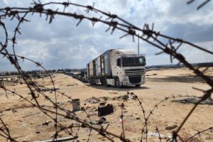 Palestinian truck drivers and United Nations vehicles wait near the Rafah border gate after the Israeli army took control of the Rafah Border Gate, Gaza on May 14, 2024.