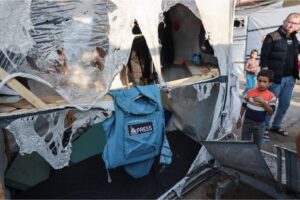 A press jacket hangs near the site of Saturday’s helicopter attack against tents housing war-displaced Palestinians at Al-Aqsa Hospital in Deir el-Balah, Gaza