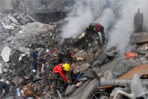 Civil Defense teams search through piles of debris after an Israeli attack that destroyed an eight-story building in central Beirut, Lebanon on Saturday