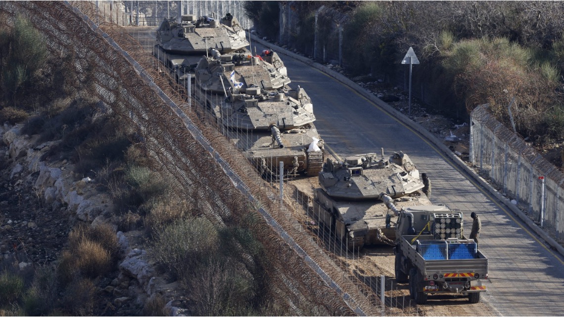 Israeli tanks take position on the border with Syria in the Israel-annexed Golan Heights on Dec. 8, 2024.