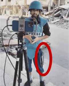 Journalist Mohammed Baalousha, seen here reporting with metal rods holding his bones together after he was shot in the leg by an Israeli sniper, was killed Saturday, Dec. 14, 2024