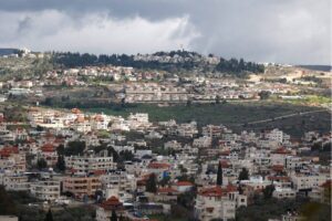 A picture taken in the village of Turmus Ayya near Ramallah city shows the nearby Israeli Shilo settlement in the background, in the occupied West Bank on 18 February, 2024