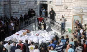 Hundreds of Christians and Muslims were sheltering in Saint Porphyrius church when an Israeli missile brought down part of the complex, killing 16 people. The bodies of those killed were laid out for a mass funeral in the church courtyard.