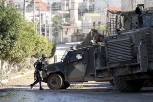 Israeli military vehicles patrol the streets of the Tulkarem Refugee Camp during a brutal December 2024 raid.