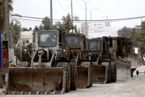 Israeli military vehicles and construction equipment patrol the streets as Israeli occupied army continues its attacks in West Bank city of Jenin, on January 22, 2025