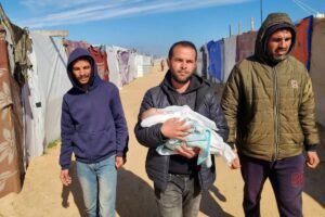 Relatives of the 2-month-old baby Shem Al Shambari, who died of extreme cold, carry his body to the cemetery in Khan Younis, Gaza on February 25, 2025