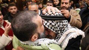 A first group of more than 600 prisoners due to be freed by Israel descended from a bus before a jubilant crowd