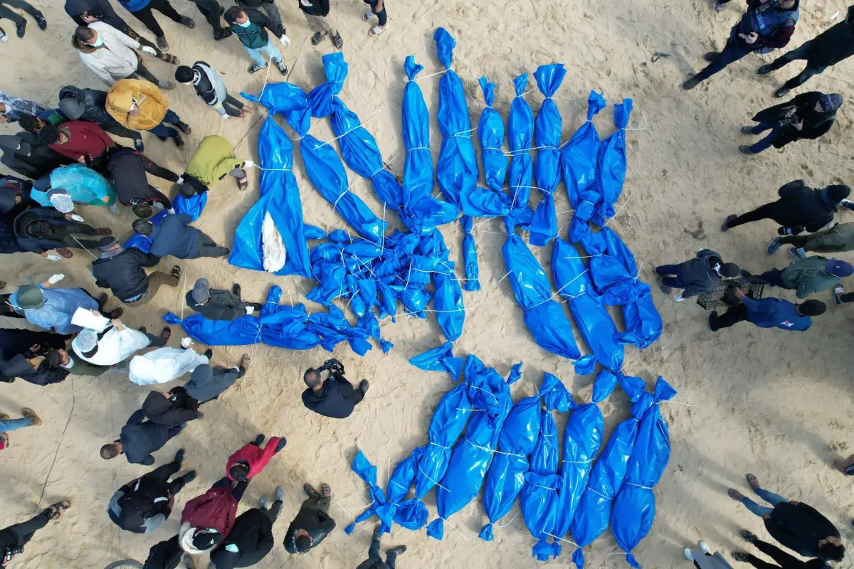 Palestinian bodies that had been confiscated by Israel were returned through the Kerem Abu Salim border crossing to be buried in a mass grave dug in Rafah, Gaza on January 30, 2024 