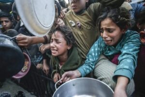 Palestinians wait in long queues to receive food after Israel stopped all humanitarian aid supplies from entering the Gaza Strip, Jabaliya Refugee Camp in Gaza Strip on March 11, 2025