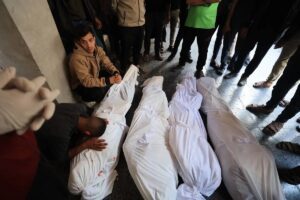 Relatives of four Palestinians, who died as a result of Israeli airstrikes in Gaza City, mourn, on March 14, 2025.