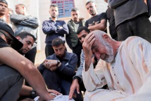 Mourners gather around the body of a victim killed by Israeli bombardment, in Beit Lahia, northern Gaza Strip, on March 15, 2025.