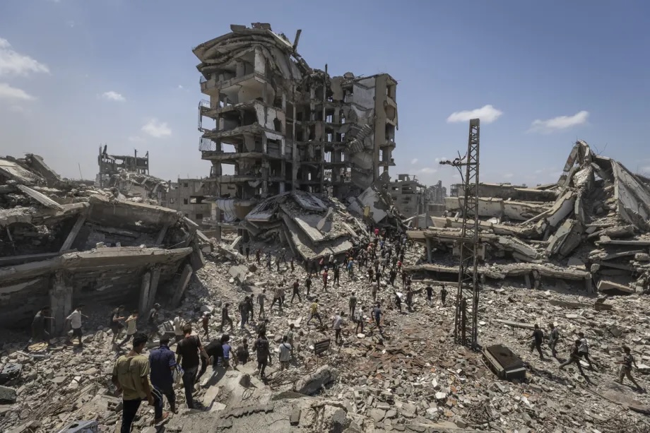 Palestinians flock to the area where the humanitarian aid packages land over western Gaza City, Gaza on August 7, 2025.