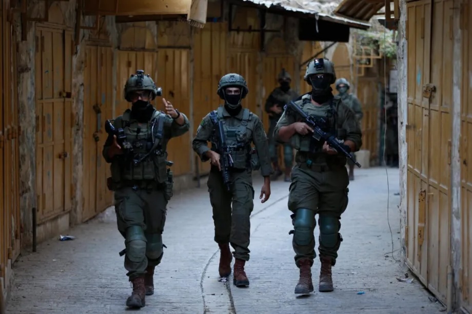 Israeli forces take security measures as Jewish settlers under Israeli protection raid on Old City in Hebron, West Bank on August 23, 2025.