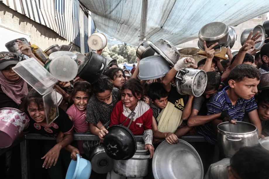 Palestinians, including children, gather during the food distribution in Gaza city center on September 10, 2025.