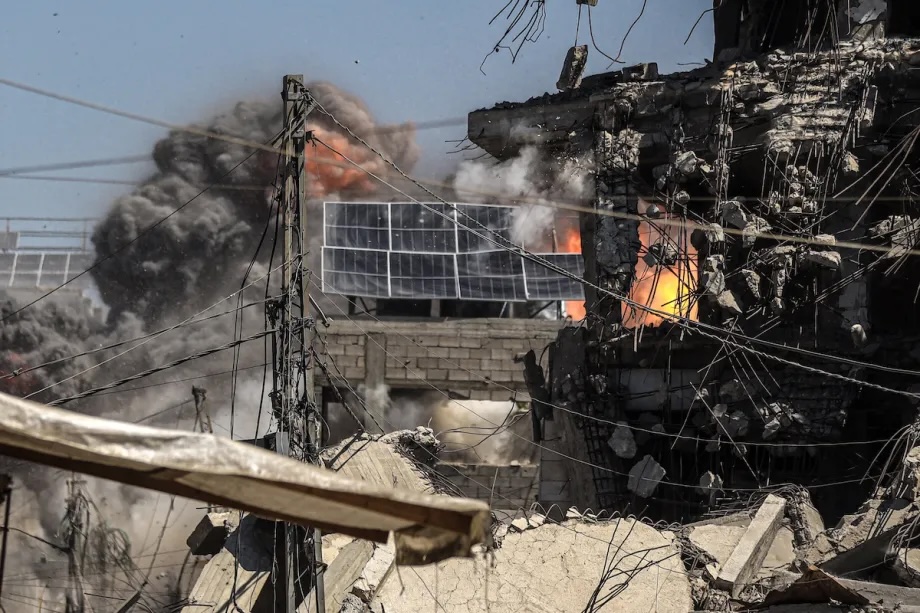 Smoke rises from three UNRWA schools and several apartment buildings, following Israeli airstrikes in the western Gaza Strip on September 13, 2025.