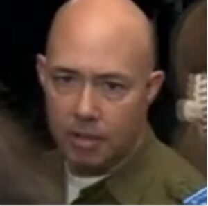 Rep. Brian Mast, dressed in an Israeli military uniform, explains that he is wearing it as a statement to counter Rep. Rashida Tlaib's Palestinian flag outside her office, October 2023.
