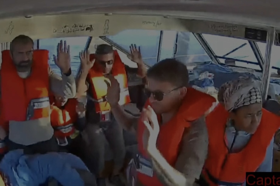 A screen grab shows activists aboard a Global Sumud Flotilla vessel raising their hands, as Israeli naval forces continue attack vessels of the Global Sumud Flotilla sailing toward Gaza to break the blockade and deliver humanitarian aid, in the Mediterranean Sea on October 02, 2025.