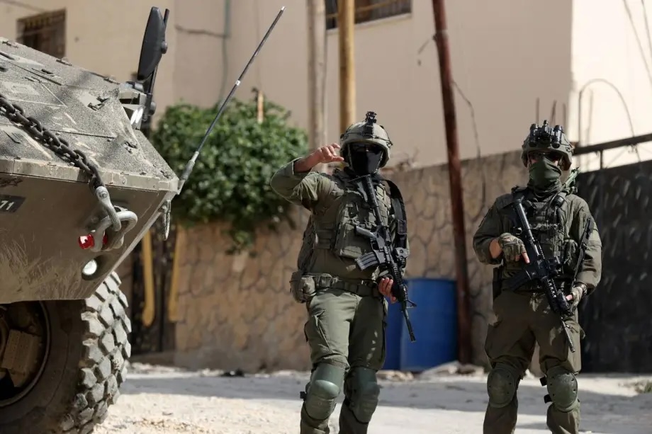 An Israeli military vehicle move through the streets, where ongoing Israeli raids have caused significant destruction since January 21, in Jenin, West Bank on March 04, 2025.