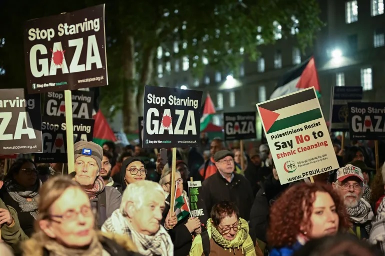 Demonstrators in London carry banners in support of the Palestinians in Gaza
