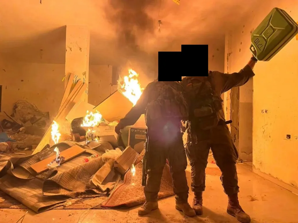 Israeli soldiers burn a home in Gaza City on the night of October 9. Source: social media. Faces obscured by Drop Site.