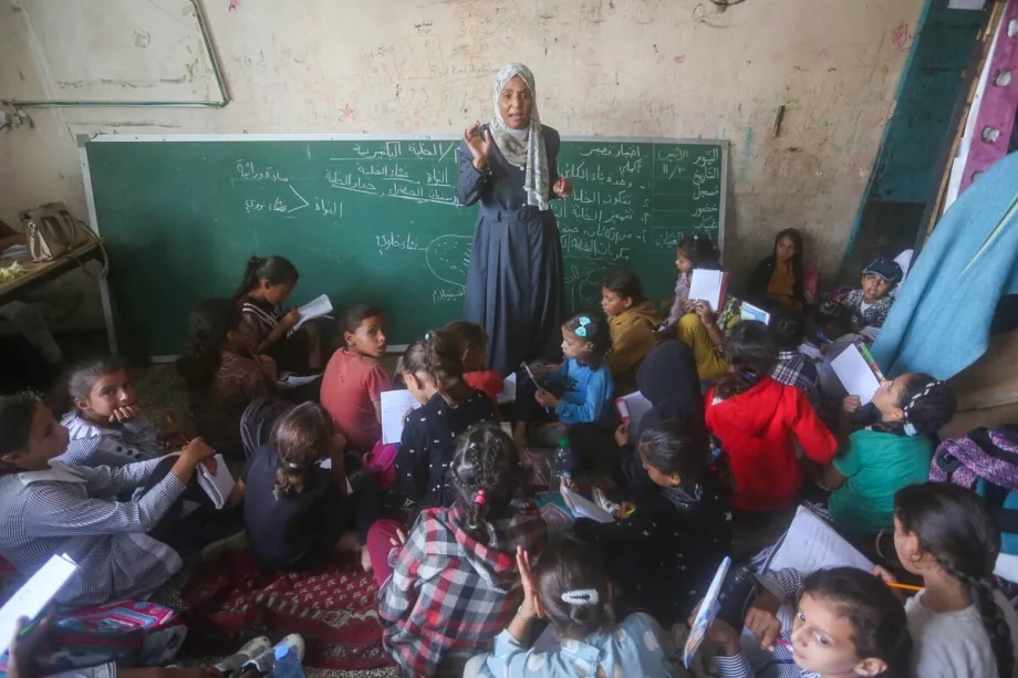 Palestinian students resume their interrupted education at an UNRWA-affiliated school, which had been converted into a shelter in Deir al-Balah, in the central Gaza Strip on November 3, 2025.