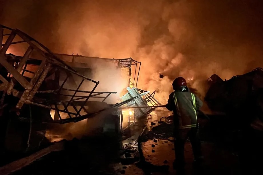 Firefighters and civil defense teams try to extinguish the fires following the Israeli attack targeting a factory causing flames and smoke to rise from the area in the town of Ansar in southern Lebanon on October 16, 2025.