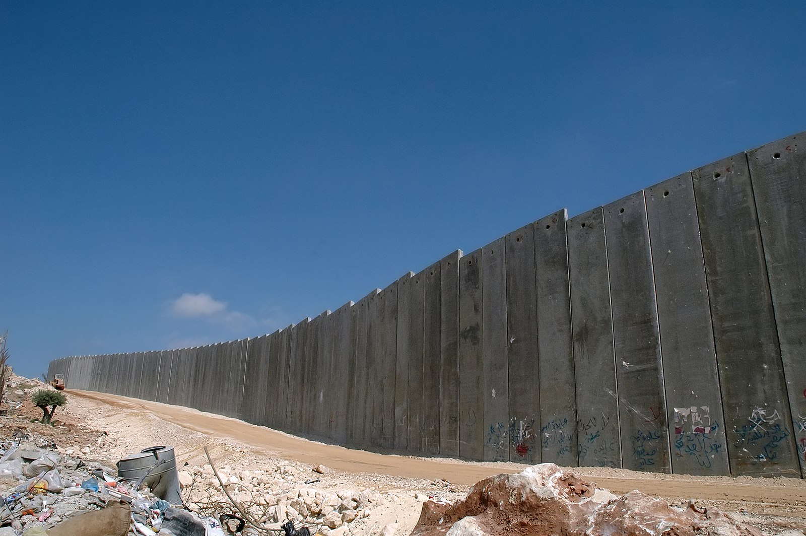Parts of Israel's "Security Fence" or "Apartheid Wall" is 10 meters (over 30 ft) high made of reinforced concrete; the majority is a complex system of electronic fences. It is over 440 miles long, and cuts off about 10% of the West Bank from its owners.