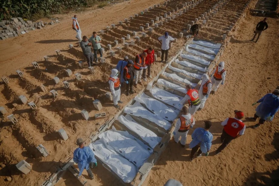 The bodies of 14 Palestinians whose identities could not be verified, were handed over by Israel, are buried in a mass grave in the city of Deir al-Balah, Gaza on November 23, 2025.