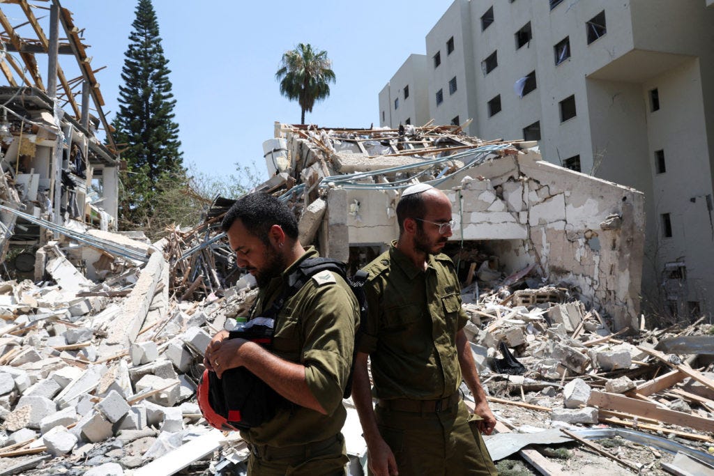 ZOF soldiers survey the wreckage of an Iranian strike on Tel Aviv, June 2025