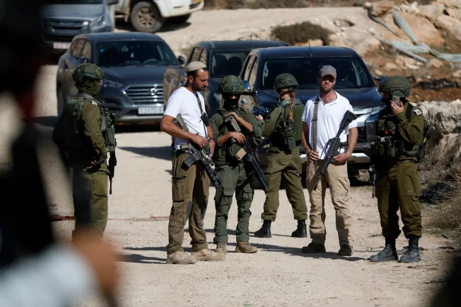Israeli forces and Israeli settlers prevent Palestinian farmers from working on their agricultural fields in the town of Beit Ulla, located west of the city of Hebron, West Bank on November 22, 2025.