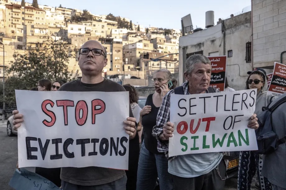 A group, holding banners and placards, gather in the Silwan neighborhood to protest Israel’s policies of frequently demolishing Palestinian homes in the area and forcing residents to relocate, in Jerusalem on November 8, 2025.