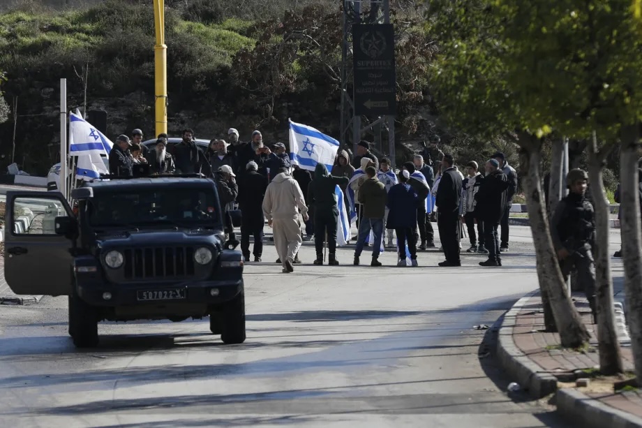 Dozens of Israeli settlers from the Kiryat Arba settlement, built on Palestinian land in the southern West Bank, raid the Kayzun area east of Hebron, accompanied by a demonstration, with Israeli flags waved and racist slogans shouted at the local population on December 10, 2025.