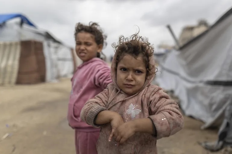 Children are seen as storm-driven waves reach tents along the coastline, with rising sea levels and heavy rain worsening conditions for displaced Palestinians living under Israel’s blockade and restrictions on aid, in Gaza City, Gaza, December 29, 2025